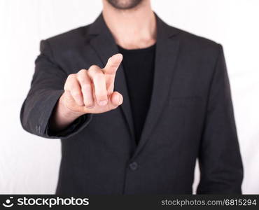 Businessman pressing an imaginary button, isolated on white