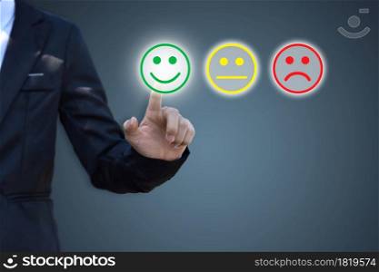Businessman pressing smiley face icon on virtual screen. Concept of satisfaction evaluation and feedback.
