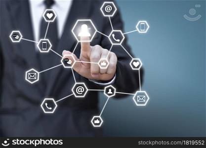 Businessman pressing social network icon button on a virtual blue background. Concept of business communication.