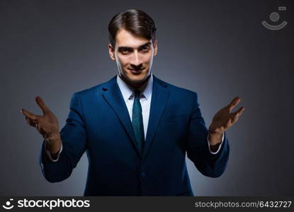 Businessman pressing virtual buttons on gray background