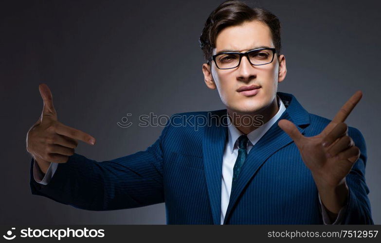 Businessman pressing virtual buttons on gray background. The businessman pressing virtual buttons on gray background