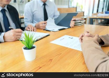 businessman professional women in suit explaining about her profile to business managers holding reading a resume, interview the job hiring career and placement concept.