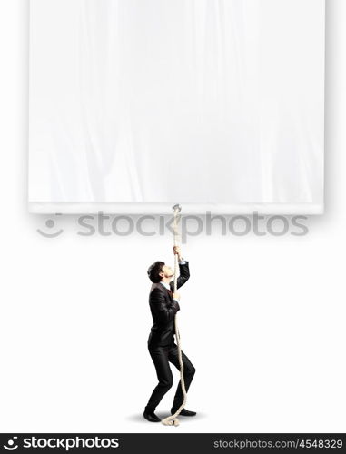 Businessman pulling banner. Image of businessman pulling blank banner. Place for text