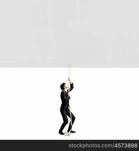 Businessman pulling banner. Image of businessman pulling blank banner. Place for text