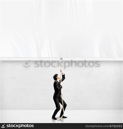 Businessman pulling banner. Image of businessman pulling blank banner. Place for text