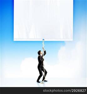 Businessman pulling blank banner