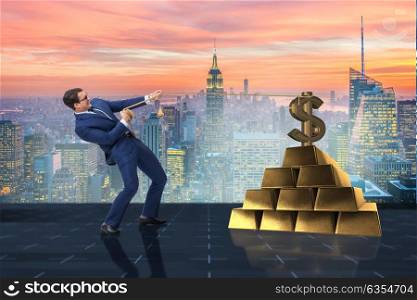 Businessman pulling dollar and gold bullions