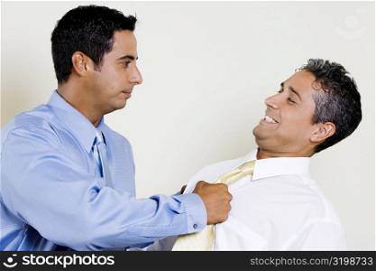 Businessman pulling his Colleague&acute;s tie