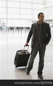 Businessman pulling his luggage at an airport
