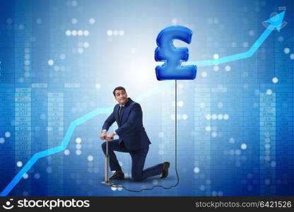 Businessman pumping british pound sterling sign in business concept. Businessman pumping british pound sterling sign in business conc