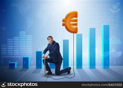 Businessman pumping euro sign in business concept
