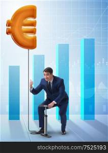 Businessman pumping euro sign in business concept. The businessman pumping euro sign in business concept