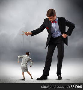 Businessman puppeteer. Image of young businessman puppeteer. Leadership concept