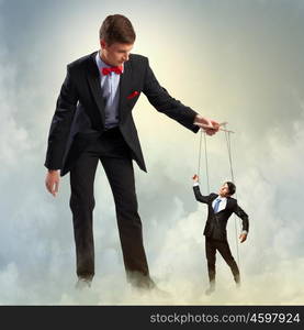 Businessman puppeteer. Image of young businessman puppeteer. Leadership concept