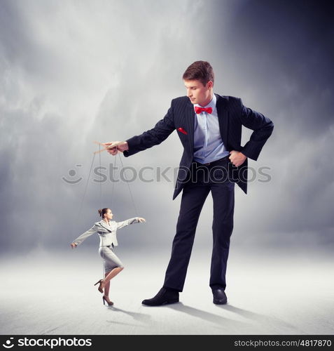 Businessman puppeteer. Image of young businessman puppeteer. Leadership concept