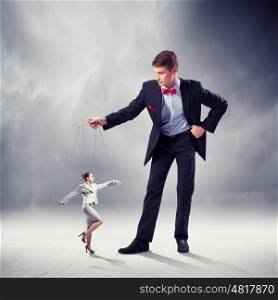 Businessman puppeteer. Image of young businessman puppeteer. Leadership concept