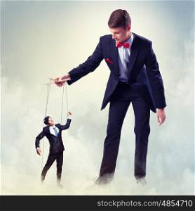 Businessman puppeteer. Image of young businessman puppeteer. Leadership concept