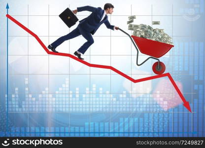 Businessman pushing money wheelbarrow down the chart