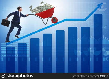 Businessman pushing wheelbarrow full of dollar money