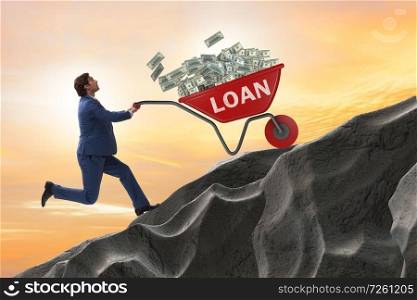 Businessman pushing wheelbarrow uphill in debt loan concept