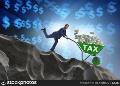 Businessman pushing wheelbarrow with tax money