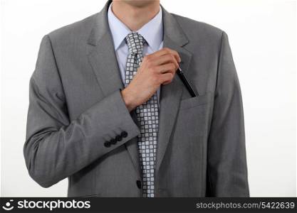 Businessman putting a pen in his pocket