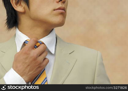 Businessman putting on a necktie
