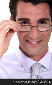 businessman putting on his glasses