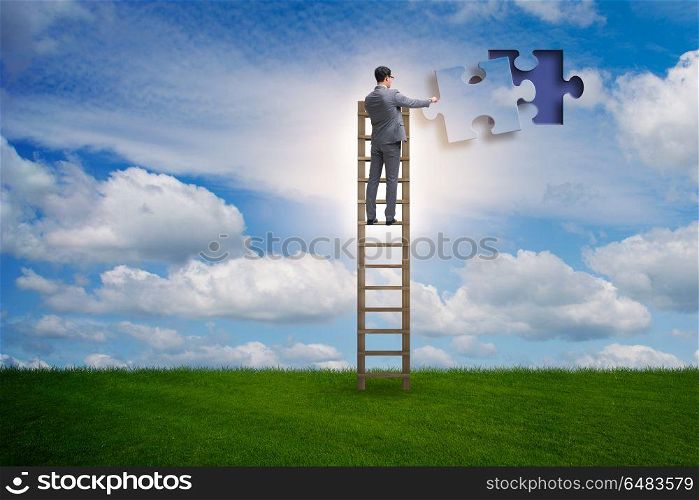 Businessman putting together jigsaw puzzle pieces