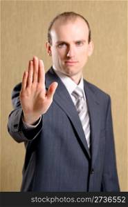 Businessman raising his hand and showing stop