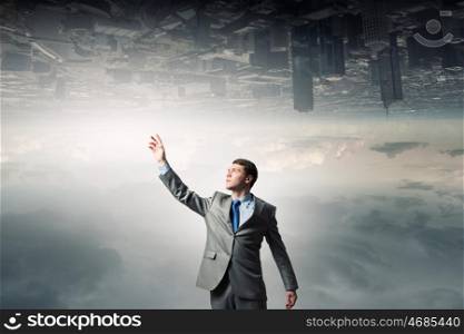 Businessman reaching arm. Businessman reaching his arm up to touch something