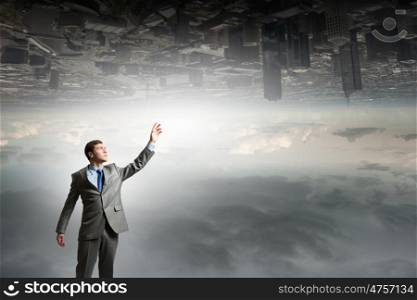 Businessman reaching arm. Businessman reaching his arm up to touch something