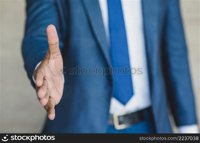 businessman reaching out his hand