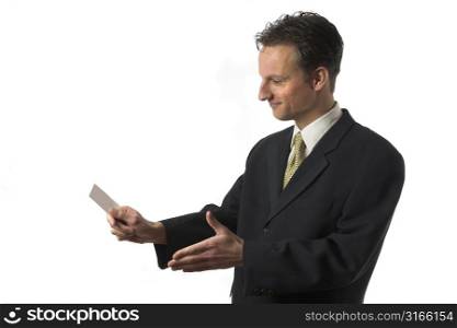 Businessman reaching out his hand to sign the deal while giving his businesscard