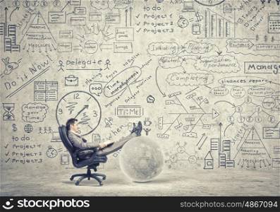 Businessman read book. Young businessman sitting in chair and reading book in hands