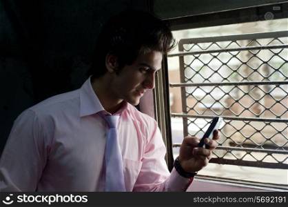 Businessman reading an sms in a train