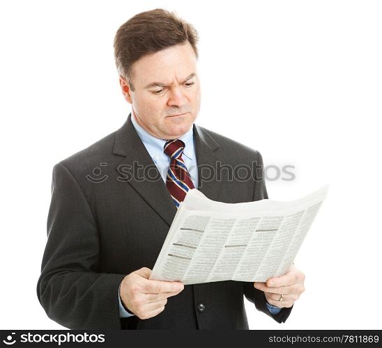 Businessman reading bad news in the newspaper. Could be financial or political news. Isolated on white.
