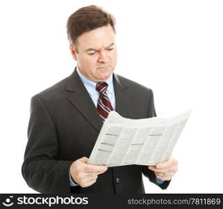 Businessman reading bad news in the newspaper. Could be financial or political news. Isolated on white.