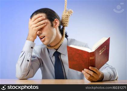 Businessman reading bible before hanging himself