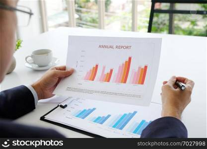 Businessman reading business information papers at office, business people, success in business concept