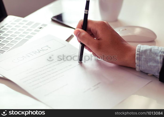 Businessman reading documents in office.