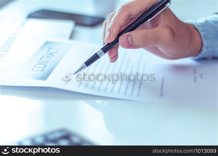 Businessman reading documents in office.