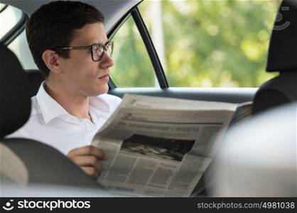 Businessman reading news in his car