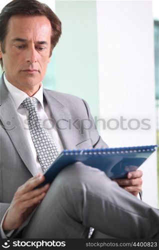Businessman reading notes.