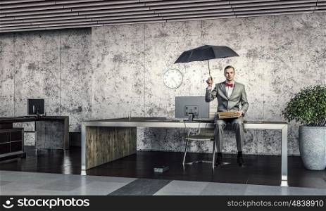 Businessman reading old book. Businessman in office sitting on table and reading old book
