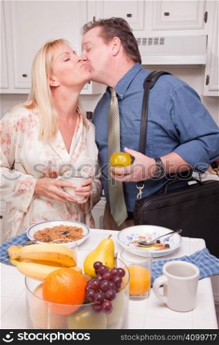Businessman Ready for Work Kisses Wife In Kitchen.