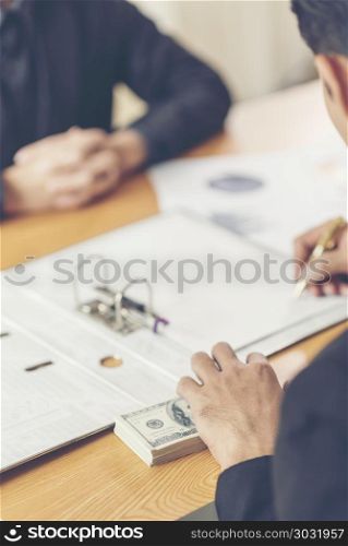 Businessman receive money in the envelope offered in file - anti bribery and corruption concepts