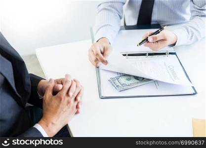 Businessman receive money in the envelope offered in file taking bribe and signing a contract - anti bribery and corruption concepts