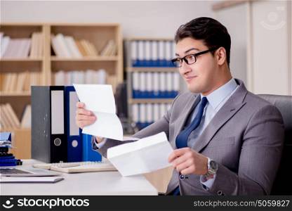 Businessman receiving letter envelope in office