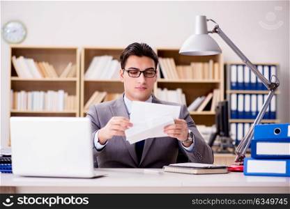 Businessman receiving letter envelope in office